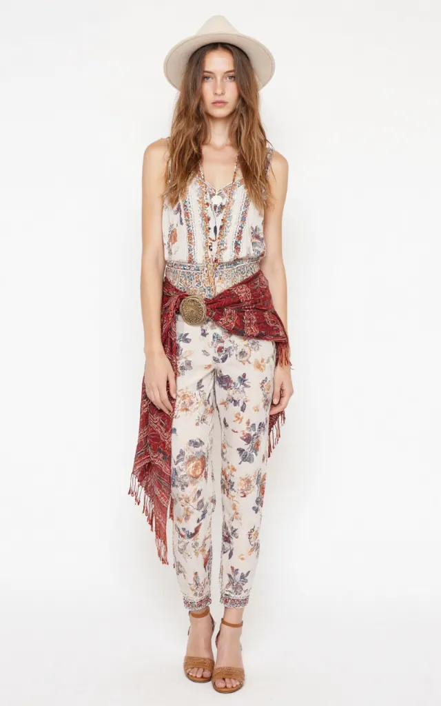 A French female model wearing Bohemian   inspired   style clothing, against a white background, in a front   facing shot focusing on shoes